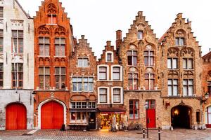 Fotografi Medieval houses standing in a row, Bruges, Belgium, Alexander Spatari