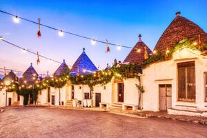 Fotografi Famous Trulli Houses in Alberobello Illuminated, roman_slavik