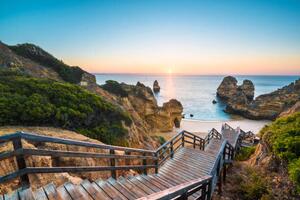 Fotografi Walkway to idyllic beach, Algarve, Portugal, Marco Bottigelli