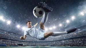 Konstfotografering Soccer player kicking ball in stadium, Dmytro Aksonov, (40 x 22.5 cm)