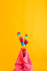 Fotografi Woman wearing colorful socks against yellow, Westend61, (26.7 x 40 cm)
