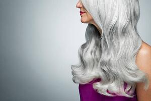 Fotografi Cropped profile of a woman with long, gray hair., Andreas Kuehn, (40 x 26.7 cm)
